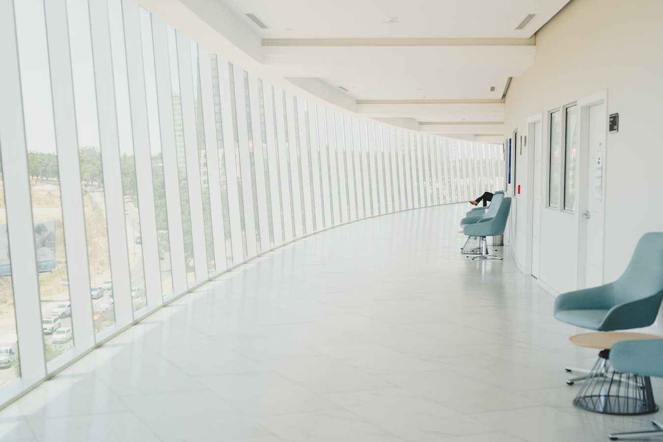 A calm, light-filled private hospital corridor