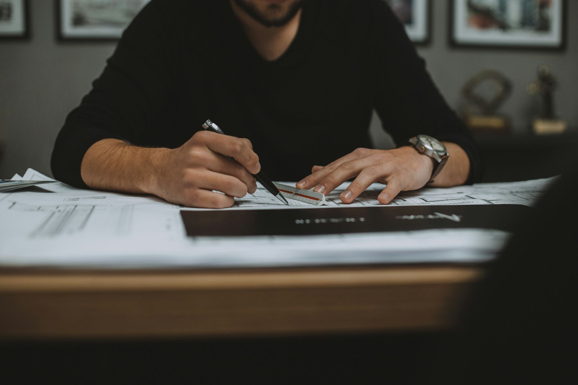 An adviser working through a client's policy paperwork at a desk