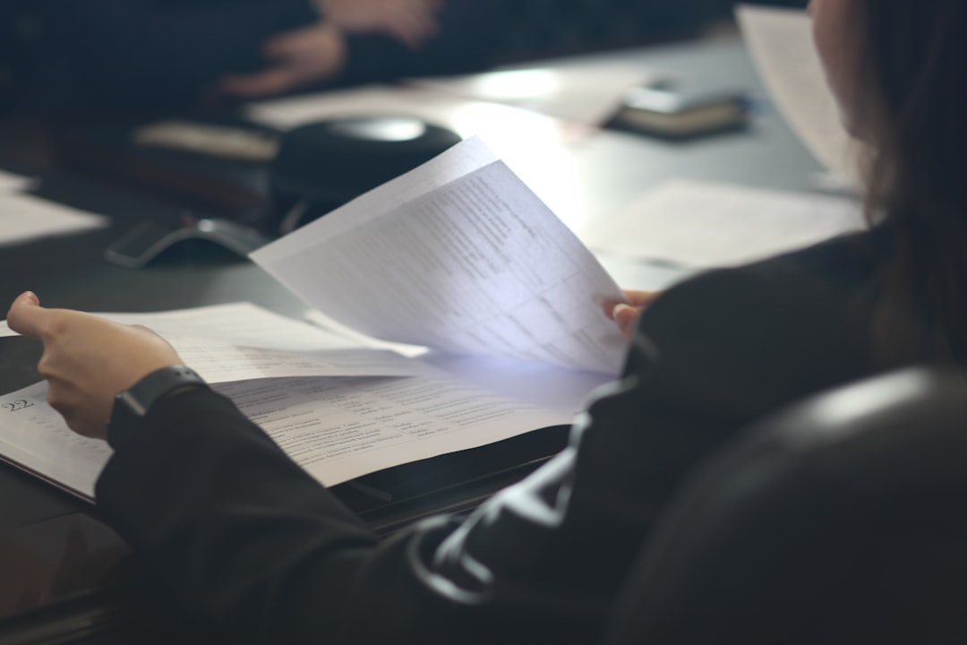 A woman reading through her life insurance policy documents at a table