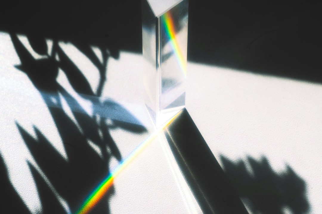 A prism splitting daylight into a spectrum, illustrating how the Chubb Life Lens facial scan reads light reflected from the skin